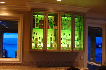 interior of Mercer Island Residence kitchen bar cabinet using green Pulsar ChromaStrip1200 LED accent lighting
