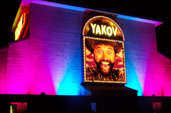 Yakov Smirnoff Show building lit pink purple aqua at night using City Color 2500 and Dominator architectural lights from Studio Due