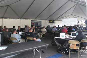 outside in back of Techni-Lux tent full of guests sitting and listening to guest speakers at the Rental & Staging Roadshow 2008 hosted by Techni-Lux, Orlando, Florida USA