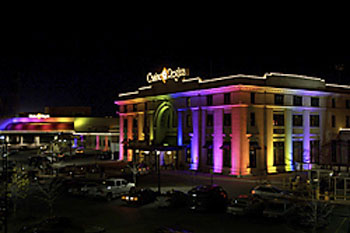 Casino Regina at night with multi-color architectural lights and fireworks in sky