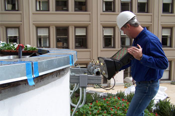 Techni-Lux Lighting Designer Tony Hansen adjusting SGM Palco LED fixture on US Grant Hotel roof