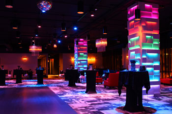 vibrant LED hues of red, orange, yellow, green, blue and purple on columns and room in The MEZZ at Sanctuary Condo Tower, Orlando, Florida USA