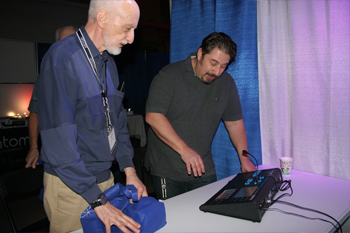 Franco Natali showing a guest the new PIVOT controller from Techni-Lux, Technology Day Open House 2018, Orlando, Florida USA