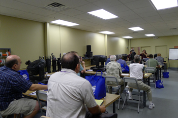 Lisa Hansen, Field Technician, teaching a class in the tech area, Techni-Lux 20th Anniversary Open House 2010, Orlando, Florida USA