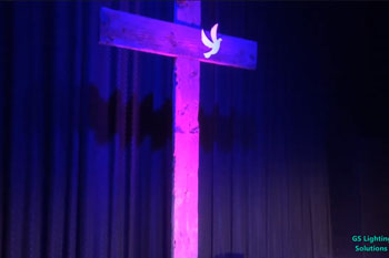 Lit cross with magenta and blue LED light Calvary Baptist at the Liberty - Ellensburg, WA