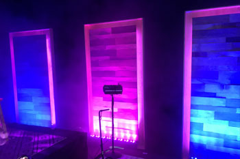 on stage close up view of with vibrant colors of magenta and blue as architectural wash from LED fixtures illuminated on the stage, UltraLED DMX Tricolor Bar inside Calvary Orlando building - Winter Park, FL, USA