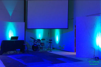 stage with instruments illuminated with architectural wash on walls with  blue LEDs inside First Baptist Church of Kent - Kent, WA, USA