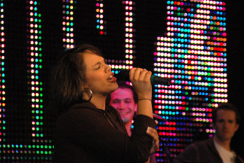 close view of singer with band performing on stage illuminated by a LED video wall in the Word of Life Center - Shreveport, Louisiana, USA