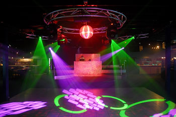 dance floor with red light on disco ball, 4 green beams of light projecting  geometric circle gobos, and magenta beams of light projecting geometric squares gobos from Techni-Lux Trackers  Aqua Lounge, Daytona Beach, Florida