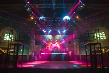 dance platforms on each side on dance floor, corner walls have video 16 monitor with abstract white and black imagery, mirror balls with beams of white light shining patterns on the walls, beams of light in vibrant hues of pink Tabu - Orlando, Florida, USA