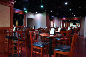 white LED lights on ceiling, bar stool chairs and tables with A-Frame Table Table Top Menus on them The Vue Lounge - Clearmont, Florida, USA
