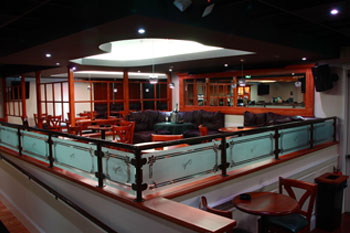 lounge with recess white LEDs fixtures and tables, chairs and sectional couches The Vue Lounge - Clearmont, Florida, USA