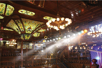 ornate floral patter stainglass on Coffered Wood ceiling with beams of multicolors on a truss  of parcans inside the Cheyenne Saloon - Orlando, Florida, USA