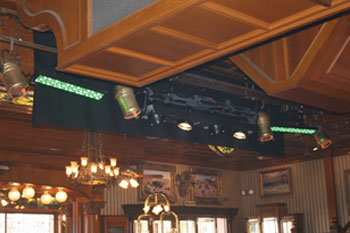 SGM Ribalta fixtures with green LEDs with gold parcans on Coffered Wood ceiling inside Cheyenne Saloon - Orlando, Florida, USA
