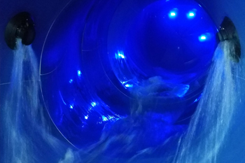 vibrant color of blue LED fixtures illuminate inside the Python Funnel Water Slide, P.A.R.C. - Frankston VIC, Australia