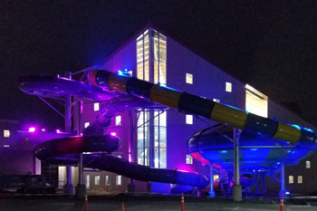 exterior section of water slide illuminated wtih vibrant purple led lights at Parrot Cove Indoor Water Park, Garden City, Kansas, USA