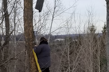 Field Technician Lisa Hansen working on juncture box for lights at Lunar Lights Tubing Peek 'n Peak Resort - Clymer, New York U.S.A.