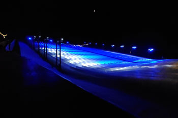 synched to music LED light show with hues of blue, aqua and white on Snowy Slopes at Snowcat Ridge Alpine Snow Park - Dade City, Florida, USA