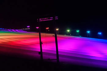 synched to music LED light show with hues of red, orange, yellow, green, purple, aqua and blue on Snow Slopes  at Snowcat Ridge Alpine Snow Park - Dade City, Florida, USA