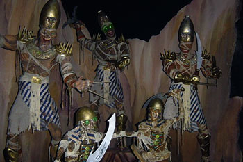 ancient eyptian skeletal guard mummies with glowing green eyes in a rocky deseart scene inside Challenge of Tutankhamon Dark Ride, Walibi Belgium
