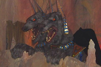 egyptian jackels baring sharp teeth with glowing red eyes in a rocky deseart scene inside Challenge of Tutankhamon Dark Ride, Walibi Belgium