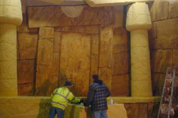 contractors working on a stone temple scene inside the Challenge of Tutankhamon Dark Ride, Walibi Belgium