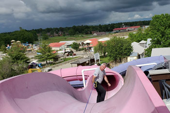 techni-lux in-house lighting designer tony hansen tethered to rope on one of the Waloopas Water Slides - Venture River Water, Eddyville, Kentucky, USA