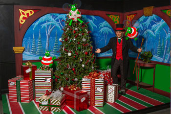 Mr. Scrooge with green humbugs beside a tree with presents underneath interior scene of The Great Humbug Adventure Dark Ride - Santa's Village, Jefferson, New Hampshire, USA