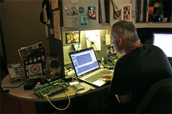 Techni-Lux in-house lighting designer Tony Hansen, programming on laptop for Justice League: Alien Invasion Warner Bros. Movie World - Gold Coast, Australia