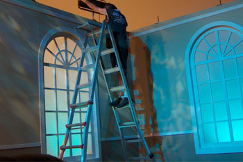 set windows blue LED wash for sky using SGM Palco 3 fixtures, person on ladder adjusting fixture on set for Central Florida Jerry Lewis Labor Day Telethon - Orlando, Florida, USA