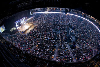 aerial view of the entire arena full of people with the stage off in the distance with a huge backdrop of intensly bright LED lit individual letters that spell out the word EPIC at the Victory World Church Epic Easter Production - Duluth, Georgia