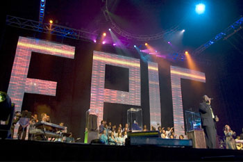 stage with musicians performing and behind them a huge backdrop of intensly bright LED lit individual letters that spell out the word EPIC at the Victory World Church Epic Easter Production - Duluth, Georgia