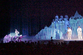 group of people dressed as shephards point at angels in front and on the white mountainous prop soft blue spot lights on the and the mountain and white spot light on the angels on stage and the people pointing, Gabriel's Christmas Story, Calvary Orlando, Winter Park, Florida, USA