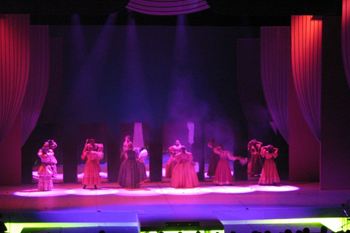 female dancers dressed in 18th century gowns with beams of red spotlights on them  on the stage in the play Glamur, Sexo, Divas y Otras Mentiras - Teatro Nacional, Dominican Republic